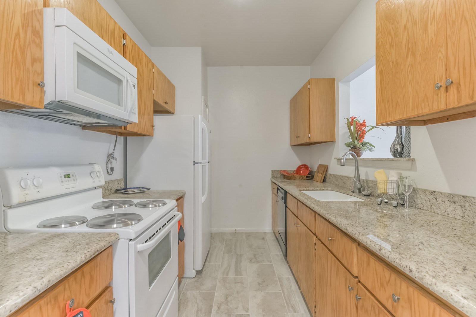 3126 Holly Hall Street Houston, TX 77054 - Photo 13 of 36 The kitchen provides tile flooring, wood cabinets with spacious storage, granite counters, undermount sink and a pantry.