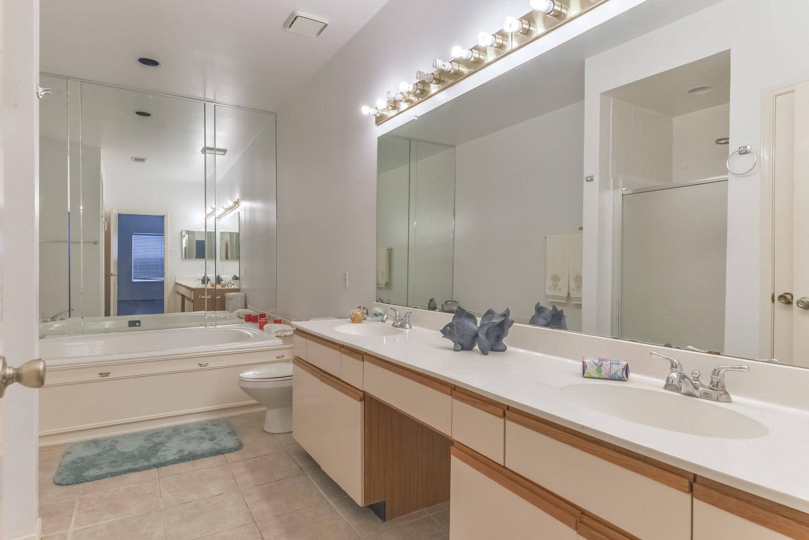 3126 Holly Hall Street Houston, TX 77054 - Photo 25 of 36 Features of the primary bathroom are tile flooring, great counter space with double sinks, good cabinet storage, a shower, large spa tub and mirrors.