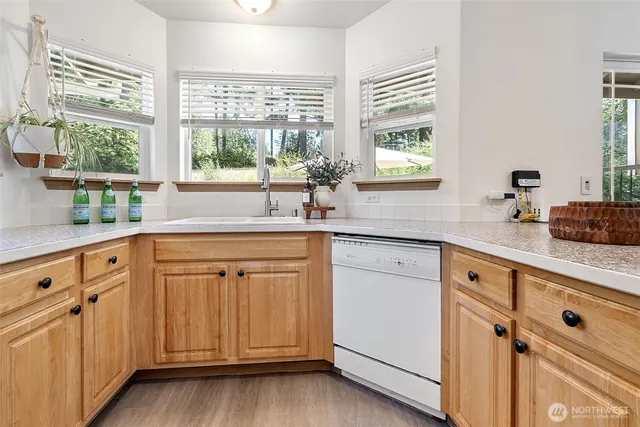 a kitchen with granite countertop white cabinets and a large window