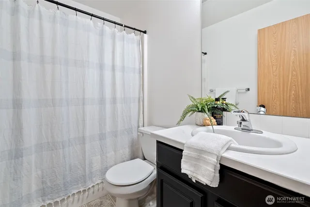 a bathroom with a sink toilet and a mirror