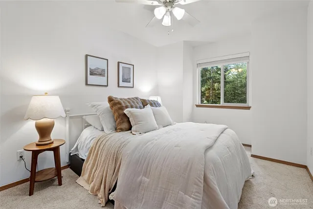 a bed room with a bed and a chair