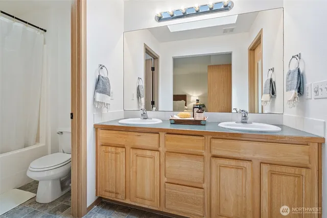 an aerial view of residential house with outdoor space and trees all around