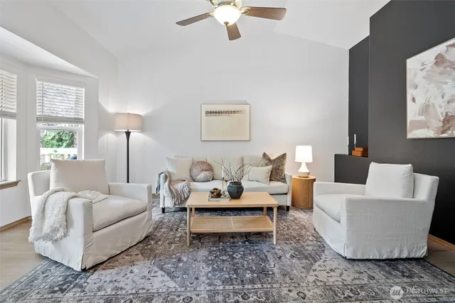 a living room with furniture and a chandelier