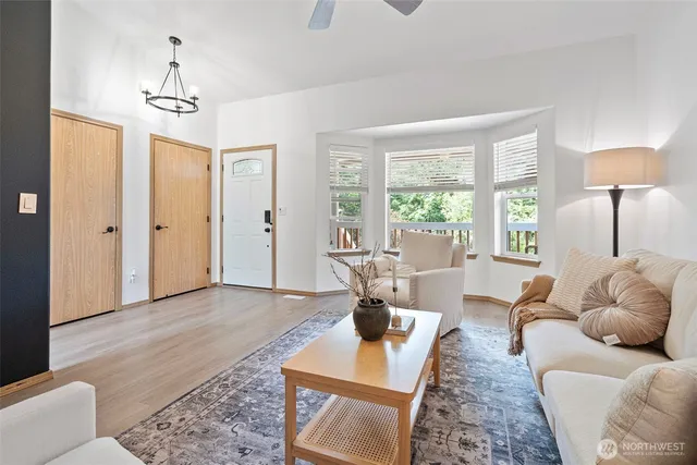 a living room with furniture and a chandelier