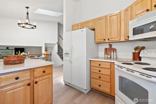 a kitchen with cabinets appliances and a counter space
