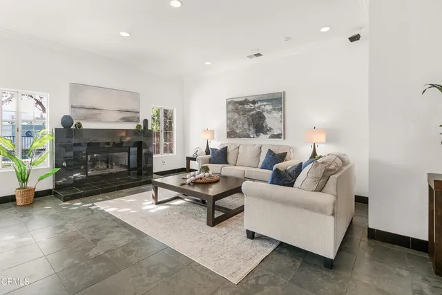 a kitchen with stainless steel appliances granite countertop a sink a stove a refrigerator and island