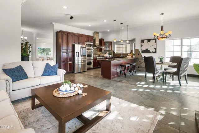 a kitchen with granite countertop stainless steel appliances and wooden cabinets