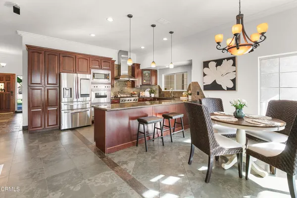 a kitchen with stainless steel appliances granite countertop a stove and a refrigerator