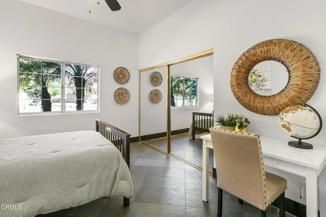 a bed sitting in a bedroom next to a window