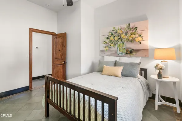 a bedroom with furniture and a large mirror