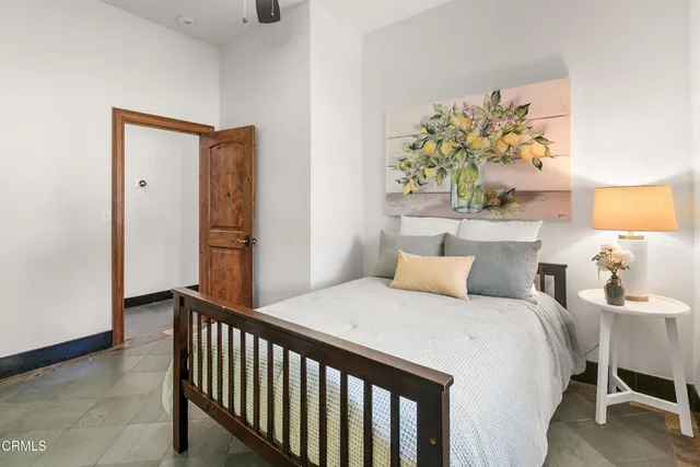 a bedroom with furniture and a large mirror