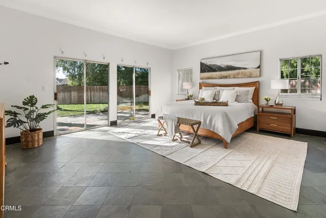 a view of a house with a yard and potted plants