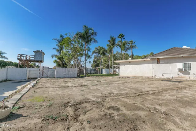 a view of a backyard with large trees