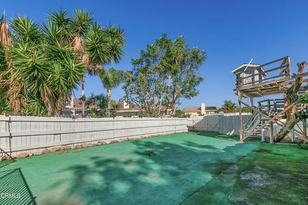 an aerial view of a house with a yard and garden