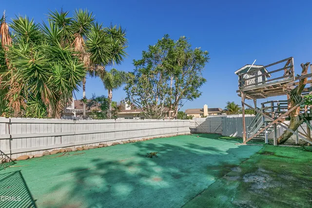 an aerial view of a house with a yard and garden