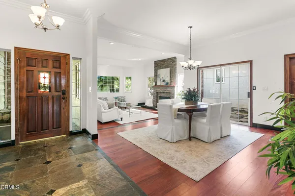 a living room with dining table and a large window