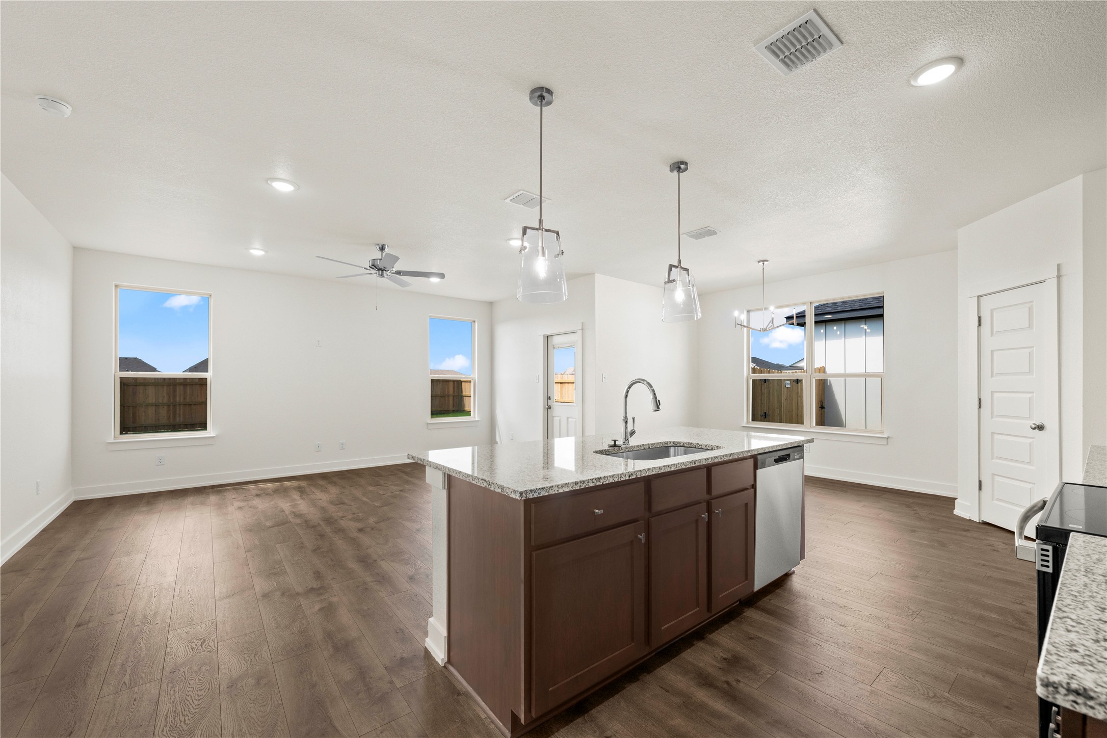 552 Gus Loop Georgetown, TX 78626 - Photo 11 of 23 a kitchen with stainless steel appliances kitchen island a hardwood floor and a sink