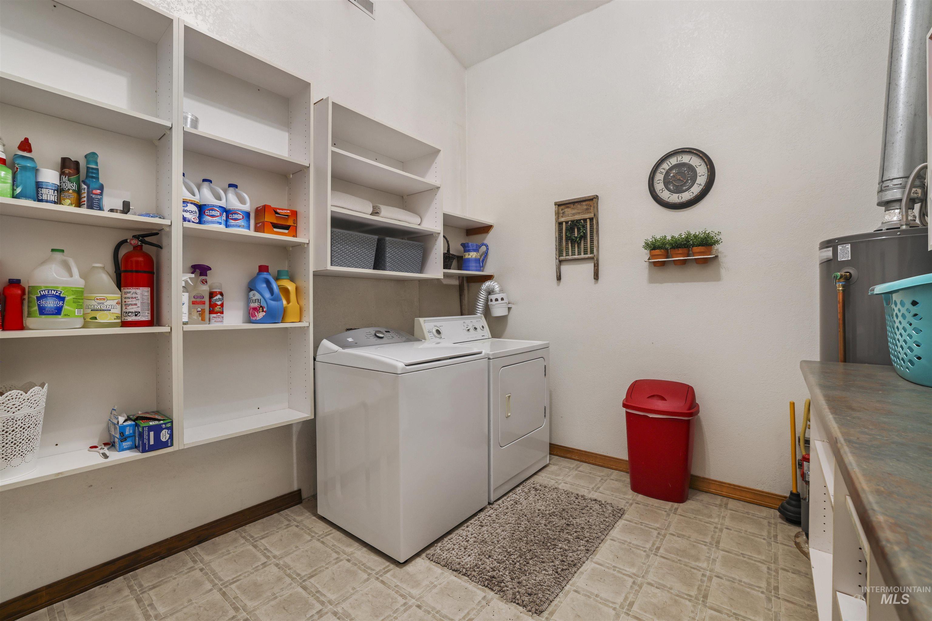 224 Dakota Road Mountain Home, ID 83647 - Photo 23 of 50 Utility room featuring extensive built-in shelving, a dedicated counter space, and durable patterned flooring