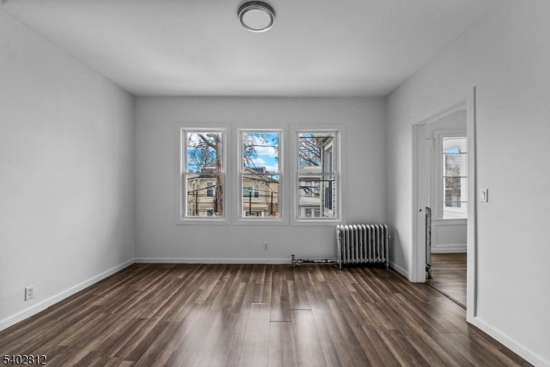 268 Leslie Street Newark, NJ 07112 - Photo 2 of 12 an empty room with windows