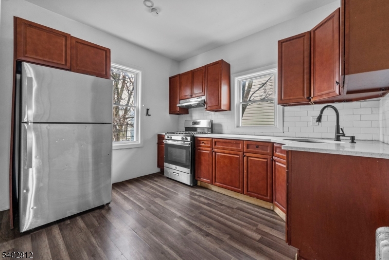 268 Leslie Street Newark, NJ 07112 - Photo 10 of 12 a kitchen with stainless steel appliances granite countertop a refrigerator sink and cabinets