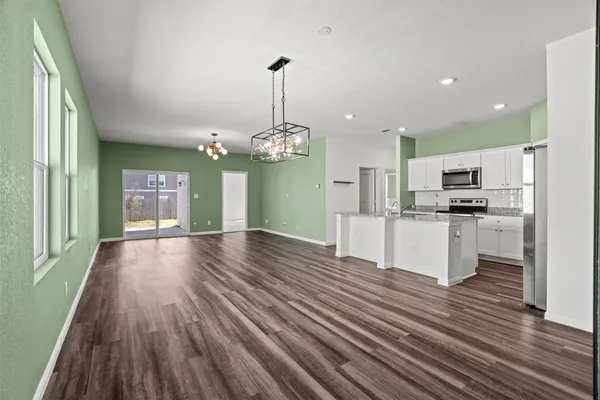 a view of a yard with wooden fence and a large tree