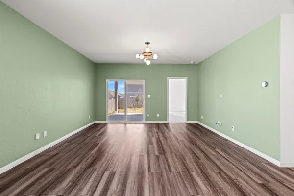 a living room with furniture a flat screen tv and a large window