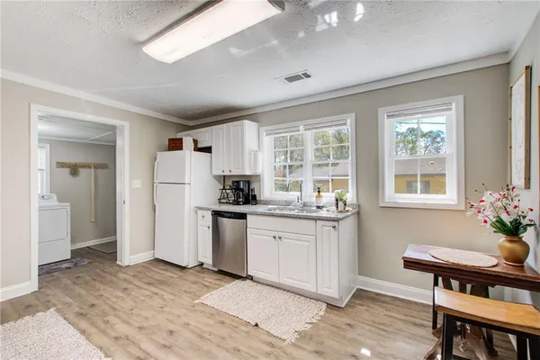 a kitchen with sink and refrigerator