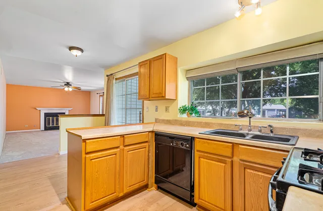 a kitchen with stainless steel appliances granite countertop a sink and cabinets