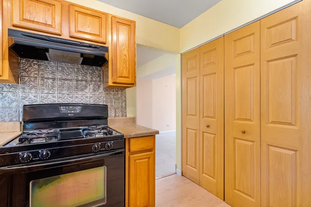 a kitchen with a stove and a cabinet