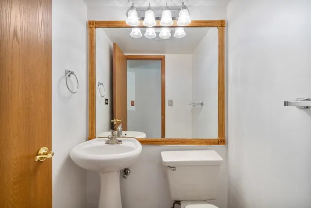 a bathroom with a sink a mirror and a toilet