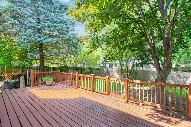 a balcony with wooden floor and outdoor space