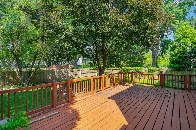 a view of balcony with wooden floor and fence