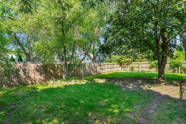 a view of a house with a backyard and a patio