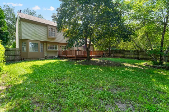 a view of a deck with a yard and fence
