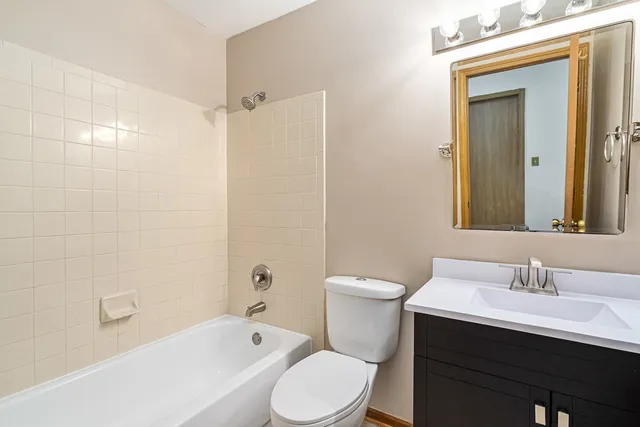 a bathroom with a sink toilet a mirror and shower