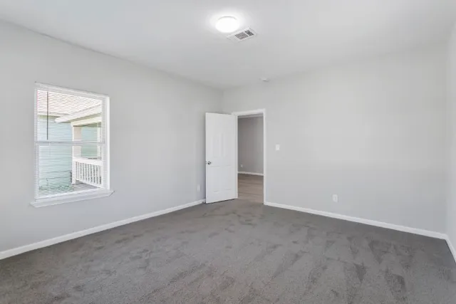an empty room with windows and closet
