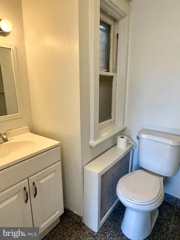 a bathroom with a toilet and a sink
