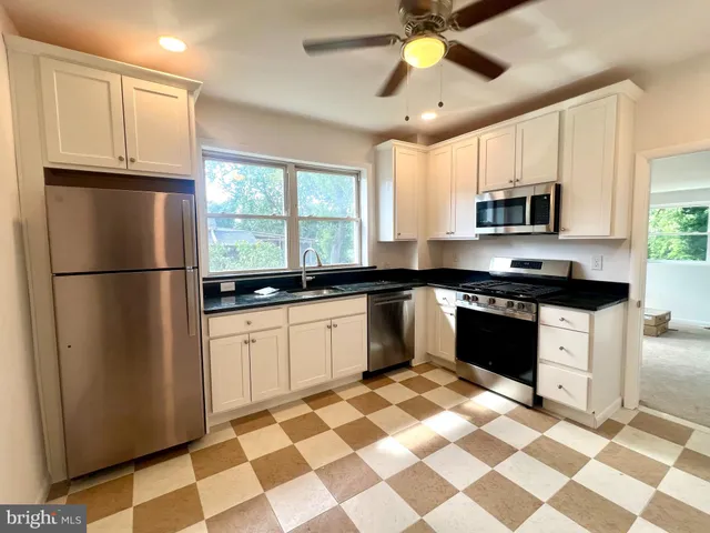 a kitchen with a refrigerator a sink and a stove