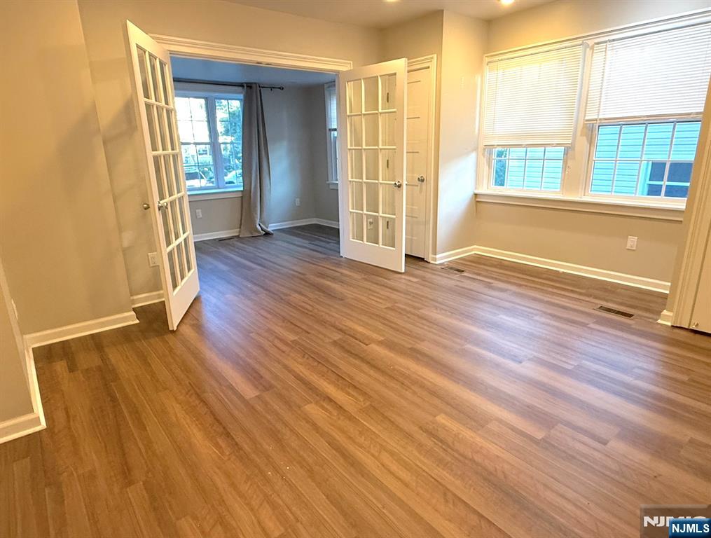 314 3rd Street Dunellen, NJ 08812 - Photo 11 of 15 an empty room with wooden floor and windows
