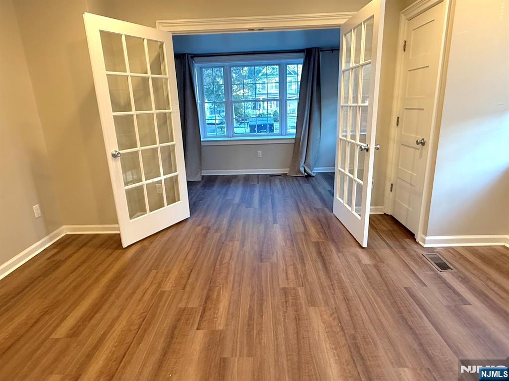 314 3rd Street Dunellen, NJ 08812 - Photo 12 of 15 an empty room with wooden floor and windows
