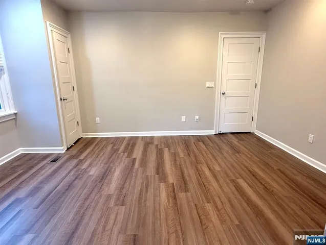 a view of a room with wooden floor and brick walls