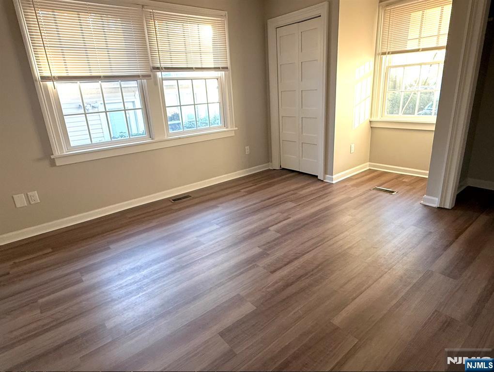 314 3rd Street Dunellen, NJ 08812 - Photo 14 of 15 an empty room with wooden floor and windows