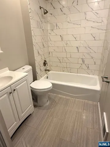 a bathroom with a toilet a sink and bathtub