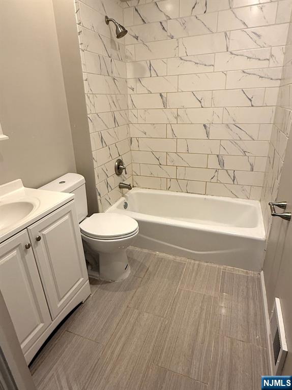 314 3rd Street Dunellen, NJ 08812 - Photo 15 of 15 a bathroom with a toilet a sink and bathtub