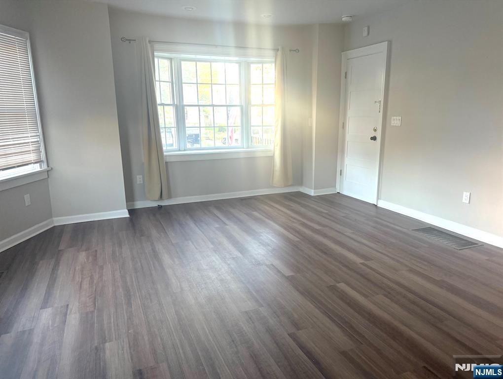 314 3rd Street Dunellen, NJ 08812 - Photo 4 of 15 an empty room with wooden floor and windows