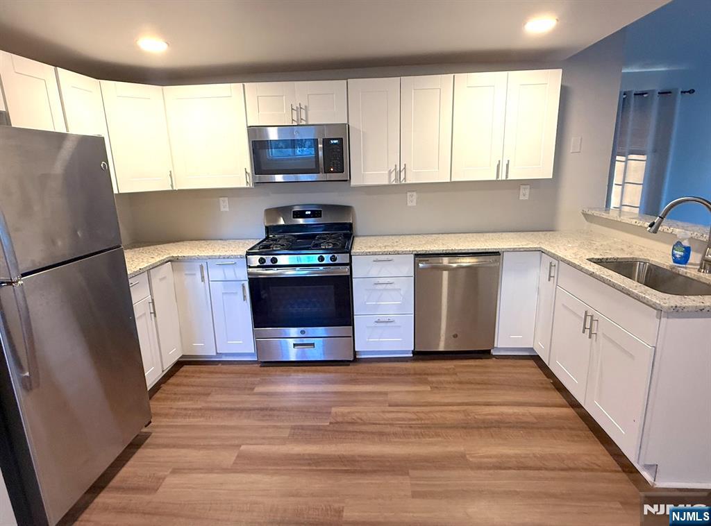 314 3rd Street Dunellen, NJ 08812 - Photo 7 of 15 a kitchen with stainless steel appliances a stove a sink a refrigerator a window and a counter space