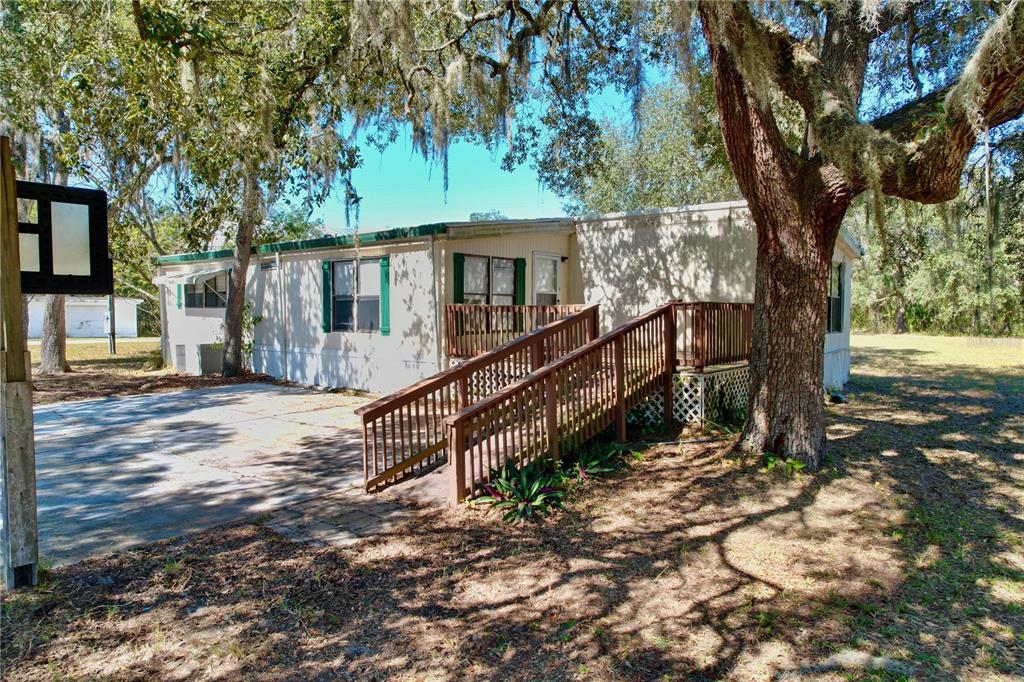 16139 Memory Lane Spring Hill, FL 34610 - Photo 1 of 1 a house that has a tree in it