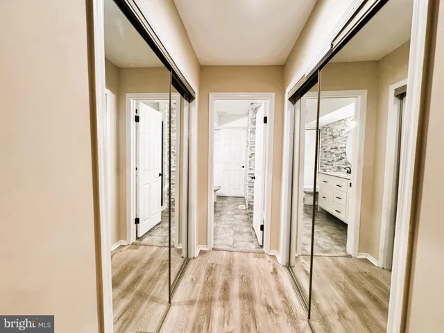 a bathroom with a double vanity sink a toilet and a mirror