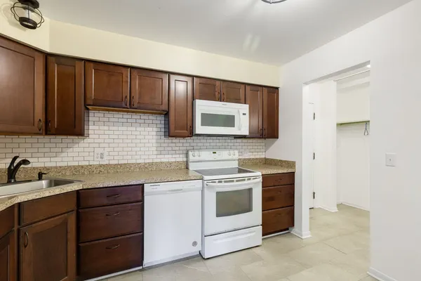 a kitchen with a stove microwave and sink