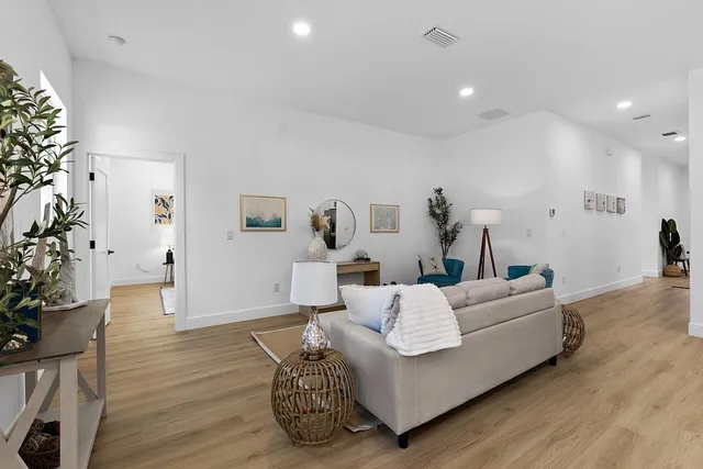 a living room with furniture and wooden floor